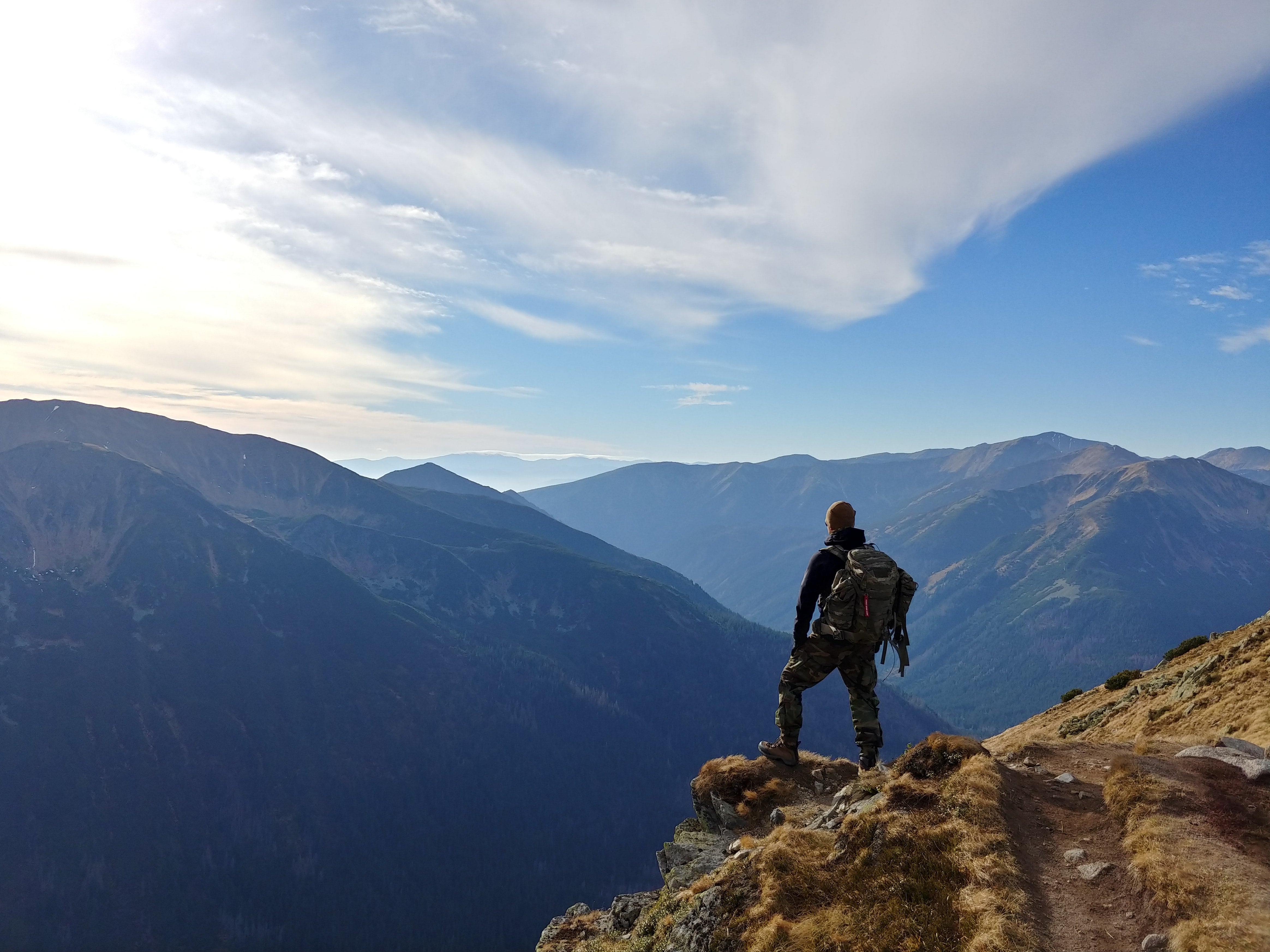 a hiker looking at the view of the mountain range